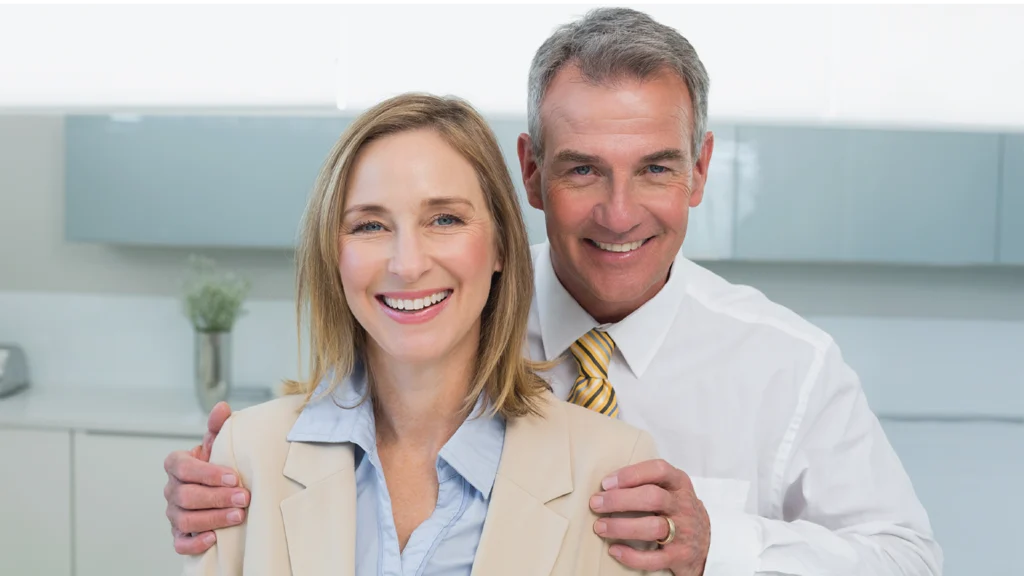 Middle-aged Albuquerque couple smiling after dental visit.